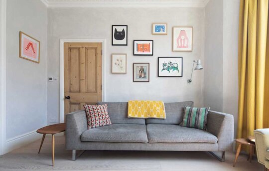 The Green House featuring Hollington Extra Wide Plank. Living room with wall art and grey couch