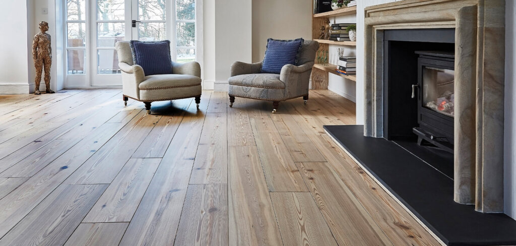 Reclaimed North Bank Pine plank flooring roomshot with two armchairs and fireplace