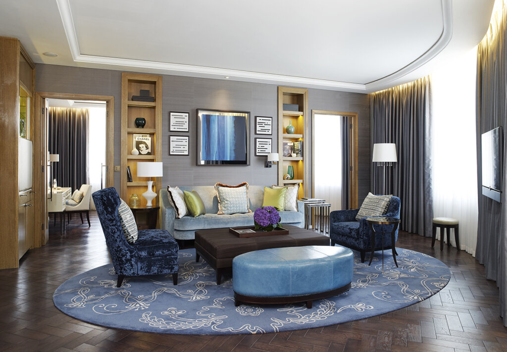 Living room sitting area, with blue toned furniture in a large spacious room. 