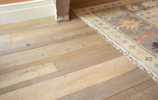 Baslow Random Width Plank close up with rug