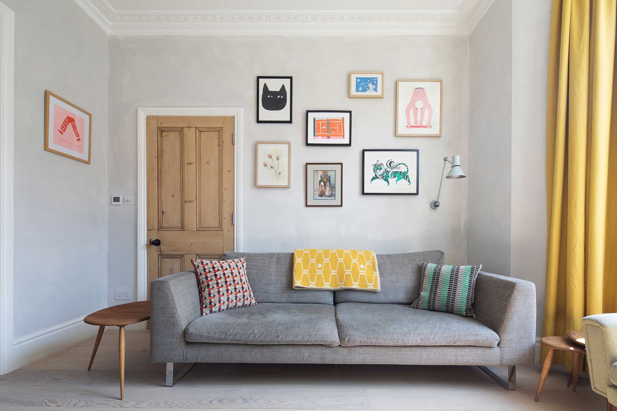 The Green House featuring Hollington Extra Wide Plank. Living room with wall art and grey couch