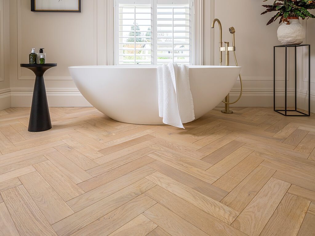 Petworth Herringbone in bathroom with white free standing tub