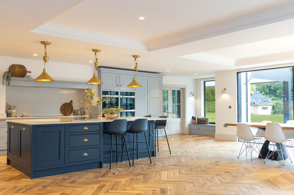 Large open-plan renovated kitchen, dining space using Sherwood herringbone for a warm cosy feel.
